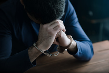 sad man hand handcuffs