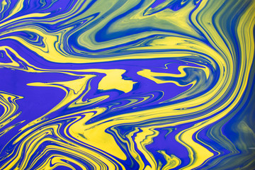 Abstract painting background in vivid colors. Marbleized bright effect with fluid painting, background for wallpapers, poster, postcard. Swirls and lines with yellow and blue. Pop crazy colors