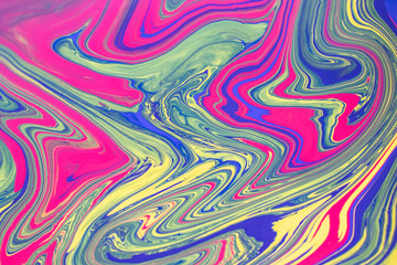 Abstract background with psychedelic  vivid colors. Marbleized bright effect with fluid painting, background for wallpapers, poster, postcard. Swirls and lines with yellow, blue, purple and magenta.