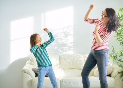 Mother And Daughter Dancing Together