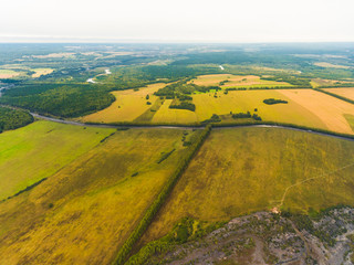 Panoramic aerial view of fields, road and river. Bird's-eye view of the land with fields, meadows and forest