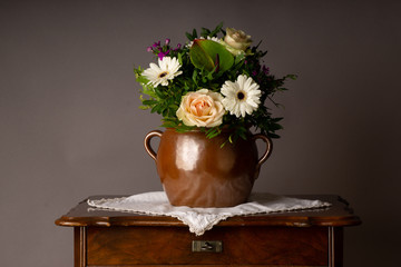 bouquet of flowers, on old coffee-table with old ceramic vase