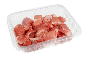 Fresh pork  fillet is cut into small pieces  in plastic container isolated