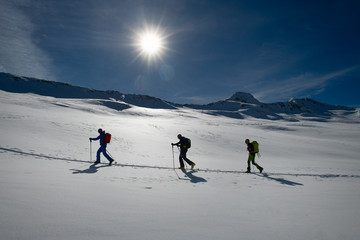 Rope of three ski mountaineers on a climb track