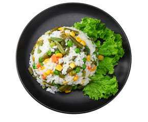 black plate with white rice, green peas, canned corn kernels, cut green beans isolated on white background. top view