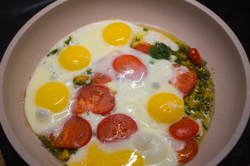 Colorful and healthy Breakfast: eggs with tomato and herbs