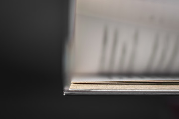 A macro photo book with moving pages on a black background