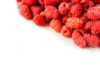 Fresh raspberries closeup on white background. Top view. Background of red berries. Various fresh summer fruits. Red raspberries. Red food. Berries at border of image with copy space for text.