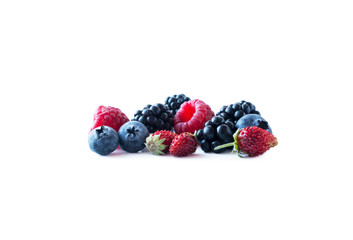 Berries isolated on white background. Ripe blueberries, blackberries, raspberries and wild strawberries. Background of mix berries with copy space for text. Mix berries on white background.
