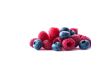 Berries on white background. Ripe blueberries and raspberries. Background of mix berries with copy space for text. Mix berries on white background. Pink and blue food on white background.
