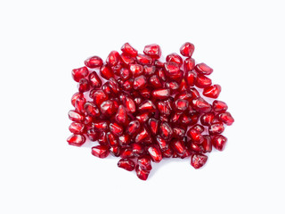 Pomegranate seeds isolated on white background. Ripe pomegranates close-up. Sweet and juicy garnet with copy space for text. Top view. Pomegranate isolated on white background. 