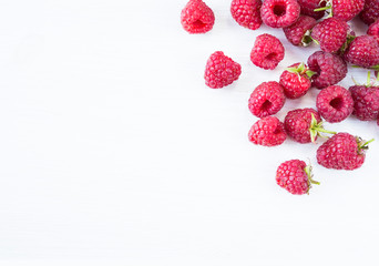 Sprinkled raspberries on white background. Ripe raspberries with copy space for text. Raspberry on a white background. Top view.
