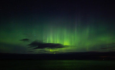 North lights Aurora Borealis seen from Atlantic Ocean road in winter night. Norwegian wintertime.