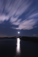 Fototapeta premium Night with the moon and view on the Atlantic Ocean Road in Norway.