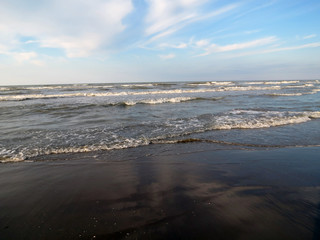Waves on a sandy beach, Adriatic coast, Rimini, Italy.