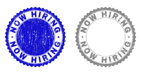 Grunge NOW HIRING stamp seals isolated on a white background. Rosette seals with grunge texture in blue and grey colors. Vector rubber watermark of NOW HIRING title inside round rosette.