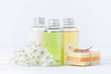 Fototapeta na wymiar natural cosmetic bottles and handmade soap bar with fresh flowers