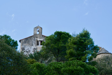 Chapel behind green trees