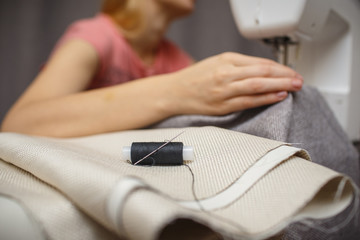 Fototapeta premium Woman working with the machine for sewing. Sewing Process