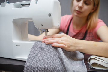 Woman working with the machine for sewing. Sewing Process