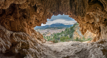 Almond tree in blossom valley from inside of the cave