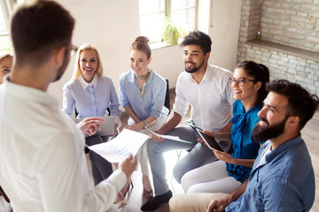 Successful happy group of people learning software engineering and business during presentation