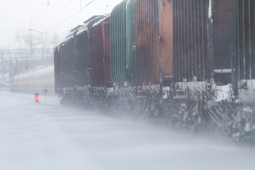 freight train rides on the railway in winter