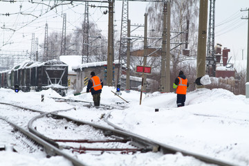 Fototapeta na wymiar workers clean the railway from snow