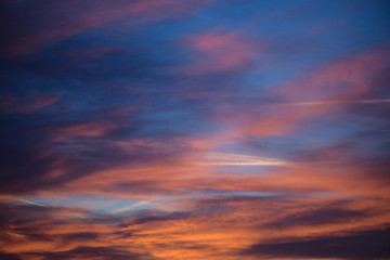 Naklejka na ściany i meble Sunset sky with clouds. Golden sunlight for your idea of web header. Cloudy landscape for background in serenity colors - blue, violet, yellow and pink tone.