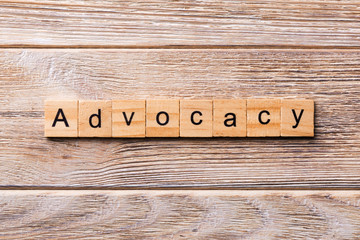 ADVOCACY word written on wood block. ADVOCACY text on wooden table for your desing, concept