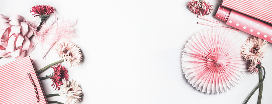 Pink accessories to various female holidays: Mothers day , Womens day, birthday or wedding. Paper shopping bag with flowers,paper, party fan and ribbon on white background, top view. Party planning - Powered by Adobe