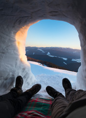 Big round igloo stands on mountains covered with snow attracting the passing by tourist sight