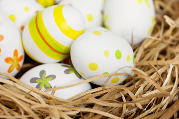 Hand painted Easter eggs on a hay