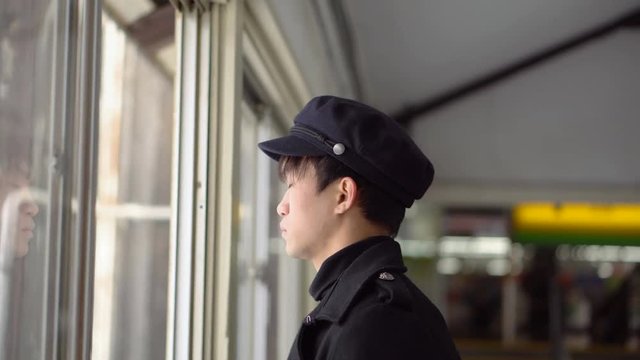 Japanese Railway Station Staff Signaling to Train with Hand Movements From Control Bridge