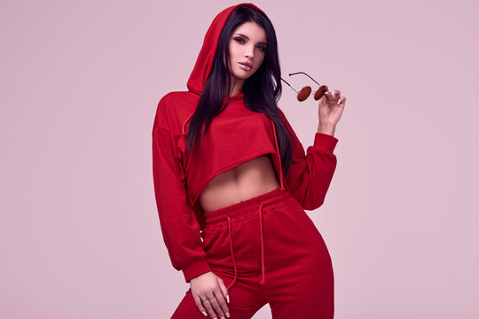 Gorgeous Brunette Woman In Fashion Red Hoodie In Studio