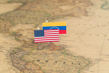 Flags of the USA and Venezuela on the world map. Conceptual photo, politics and world order