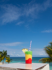 Multicolored cocktail on table  with Blue Sky in background