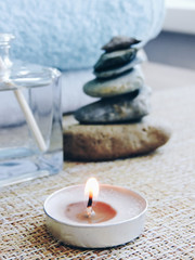 Spa treatments. Beautiful spa composition with  flowers on table close up. Spa still life with aromatic candles,candle background light  table relaxation spa beauty aromatherapy luxury closeup.