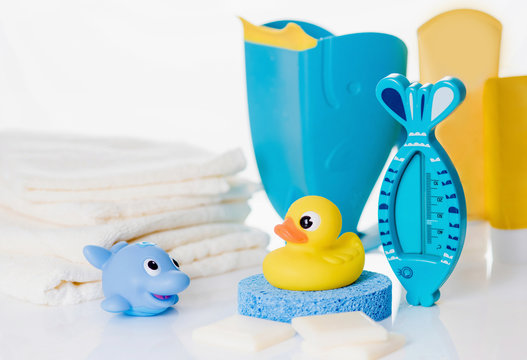 Still life with baby hygiene and bath items,    towel, pacifier, rubber toy, thermometer