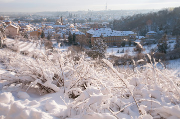 Fototapeta na wymiar View from Petrin hill to snowy Prague Mala Strana - Lesser Town