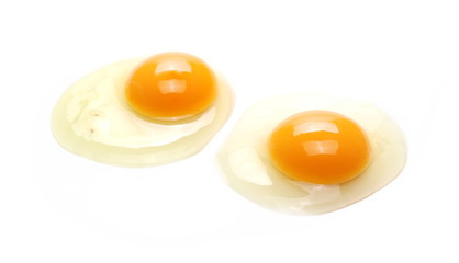 Raw eggs with yolks isolated on white background