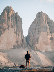 Tourist standing in front of the Drei Zinnen in the Dolomites