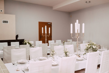 Wedding table decorated with bouquet and candles