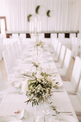 Wedding table decorated with bouquet and candles