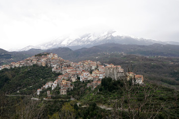 Fototapeta na wymiar winter in Calabria - village with snow covered mountain in the background