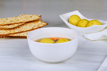 Delicious matzoh ball soup with matzah in a pot. Passover with holy food.