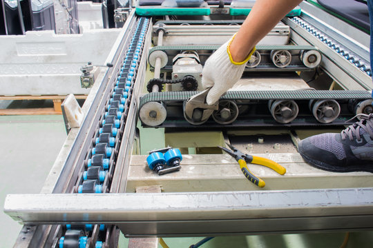 Worker Maintenance And Repair Conveyor Belt In Factory