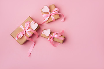 Valentine day composition: white gift boxes with bow and pink hearts. Top View. View from above.