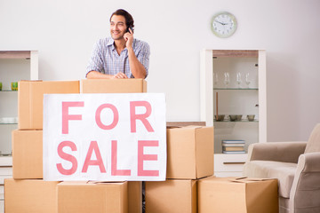 Young man offering home for sale and moving out