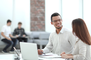 employees sitting at a table in the office .